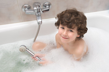 Small child happy and smiling in the bath