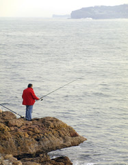 Fototapeta na wymiar Pescador en la costa