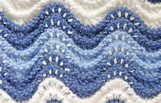 hand knitting background with lacy waves