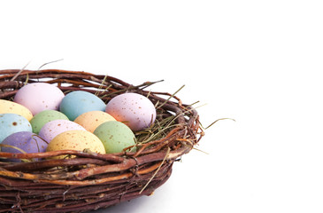 A close-up of easter eggs in a bird's nest. 