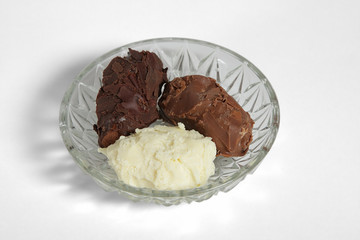 Chocolate candies in a dish izolated on white