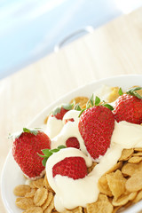 Fresh red strawberries and thick dairy cream on cereal 