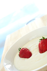 Fresh red strawberries and thick dairy yogurt for breakfast 