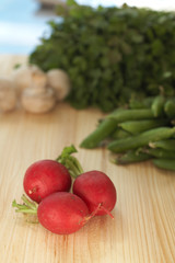 A variety of vegetables on a wooden cutting board