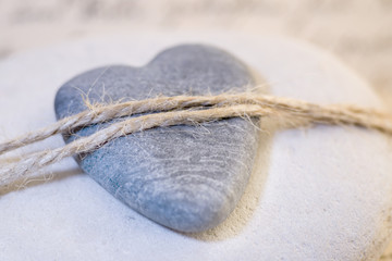 stone heart tied with rope