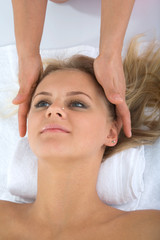Fototapeta na wymiar masseuse does relax facial massage to the girl