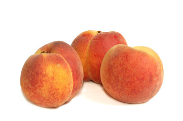 Fresh peaches against white background