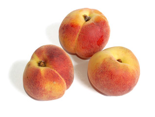 Fresh peaches against white background