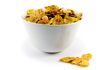 cornflakes in bowl over white