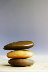 Three small river stones stacked on one another
