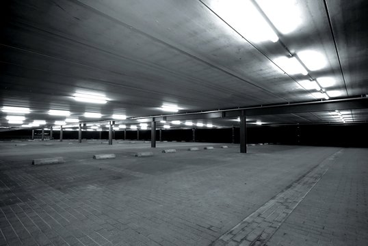 an empty spacious parking lot in black and white
