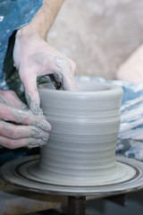 The process of shaping the pot - spin it, shape ot