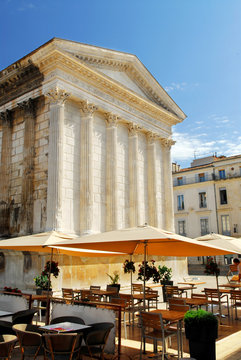 Roman temple Maison Carree and outdoor cafe in Nimes, France