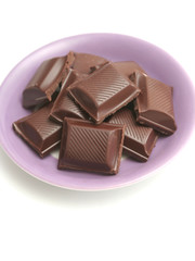 It is a lot of segments of chocolate lay on a plate