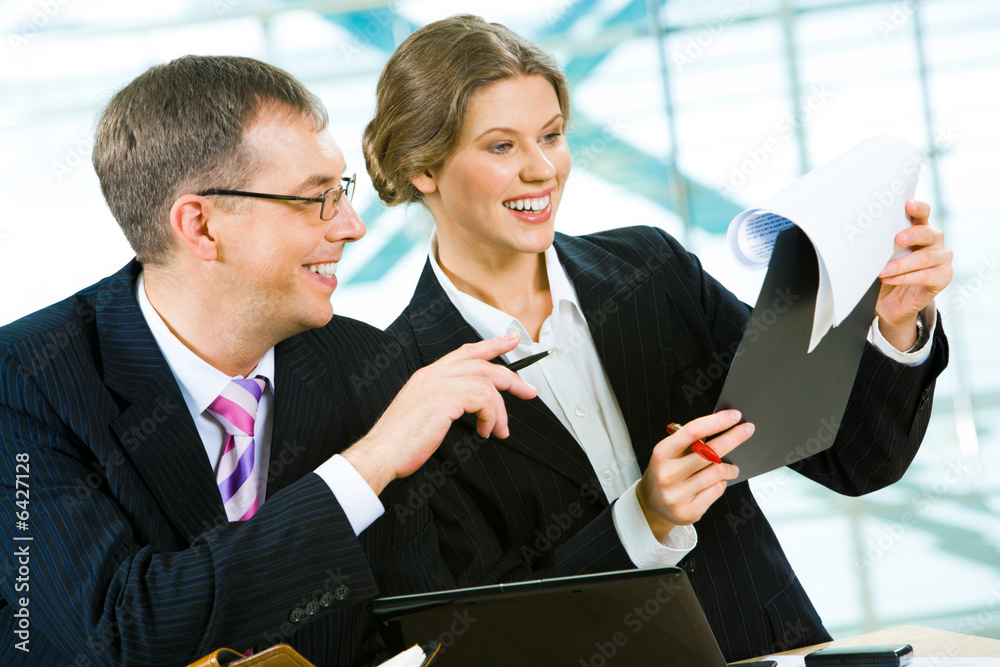 Poster portrait of two businesspeople doing together paperwork