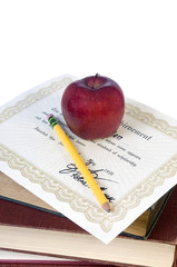 A certificate of completion. diploma with an apple an pencil