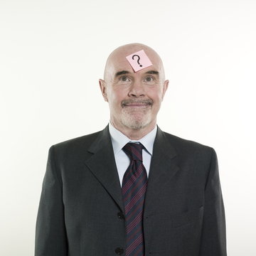 man senior having a post-it with a question mark on his head