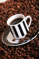 some coffee beans and a cup of aromatic coffee