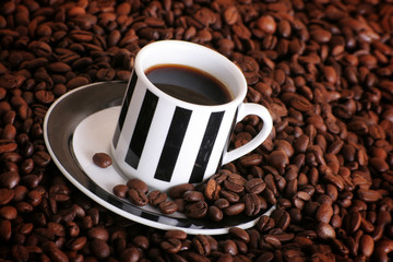 some coffee beans and a cup of aromatic coffee