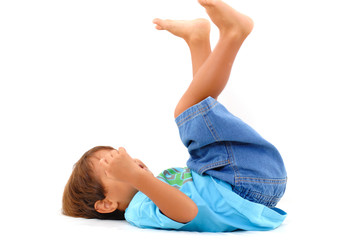 Obraz premium Boy lying playing with his legs like a bicycle