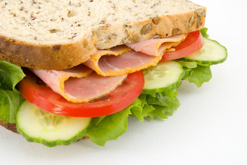 Close up side view of a ham and salad sandwich