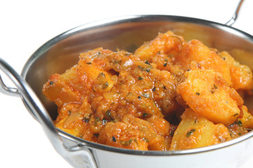 Vegetable curry with potatoes, tomatoes and fresh coriander