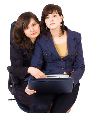 two women at the notebook shating one office chair