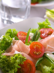 Fresh salad with ham, onion and basil