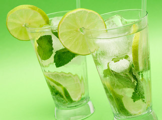 Two mojito cocktails with lime, mint leaves and ice 