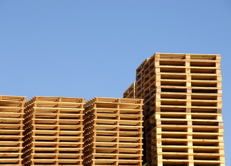 Stack of wooden shipping pallets in warehouse