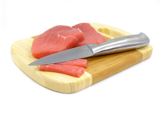 meat and knife food on the board isolated over white