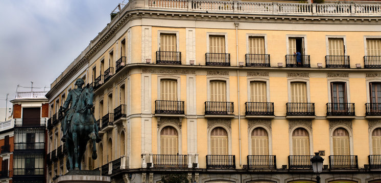 Statue of Carlos III and typical facade. Puerta del Sol. Madrid
