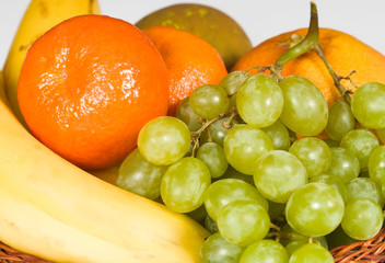 Basket with fruit isolated on white