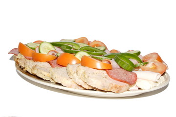 cold meat and fresh vegetables served on plate