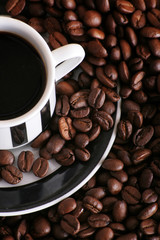 some coffee beans and a cup of aromatic coffee