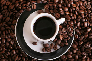 some coffee beans and a cup of aromatic coffee