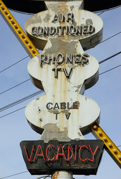 An old, weather worn hotel sign.