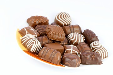 Chocolates on glass and white background