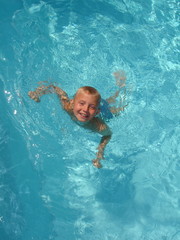 Happy boy in swimming pool