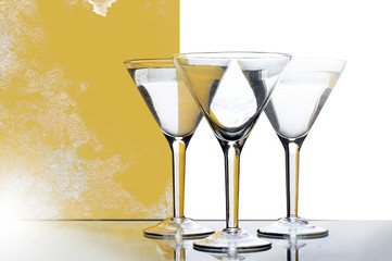 three glasses for martini with yellow reflection