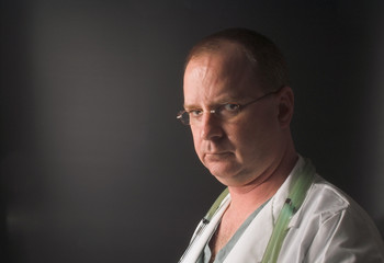 A medical doctor waiting on his next patient.