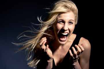 young blond woman screaming,  studio shot