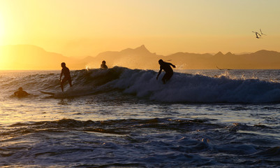 four surfers on one wave