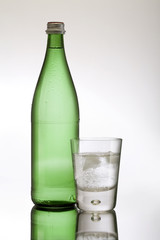 A glass of iced water and bottle