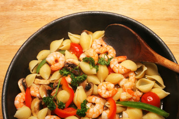 Cooked prawns and pasta in a pan