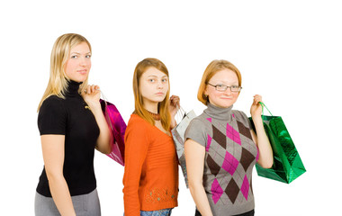 three girls posing with shopping bags over white isolated