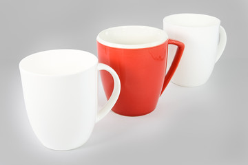 Set of three coffee mugs on graduated gray background