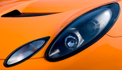 Headlight and hood of asportscar conveys a feeling of  power