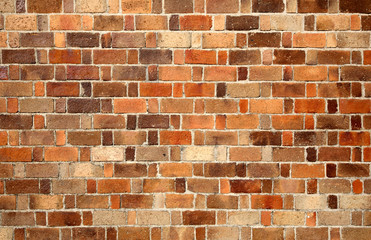 Multicolored red brick wall background.