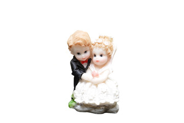 ceramic figures of children dressed as a bride and groom
